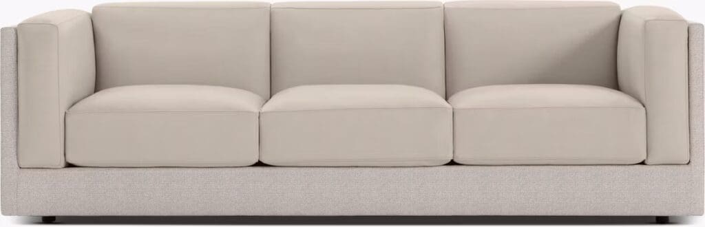 Symme Sofa from DWR Studio featuring a sleek design with a fabric and leather combination, showcasing a minimalist aesthetic and spacious cushions.