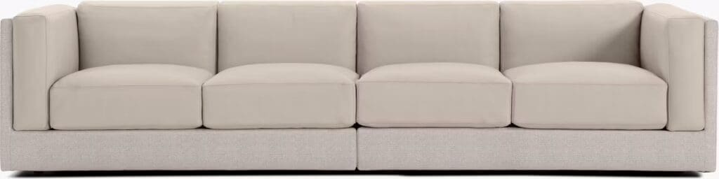 A modern beige sofa with a clean and minimalist design, featuring four plush cushions and a structured frame.