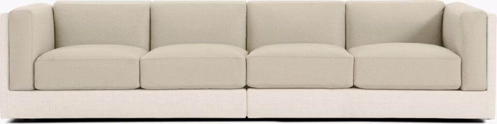 Light-colored sectional sofa with plush cushions and streamlined design.