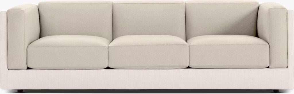 Light-colored sofa with three wide cushions and minimalist design, showcasing a modern aesthetic.