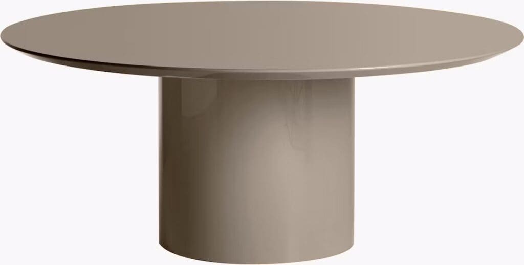 A modern round coffee table with a smooth surface and cylindrical base in a neutral color.