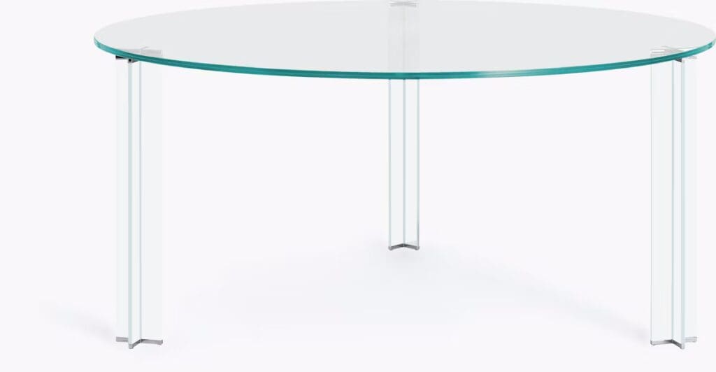 Modern round glass coffee table with transparent legs, suitable for contemporary living spaces.