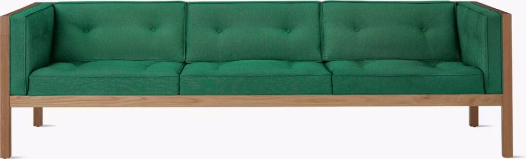Sleek green upholstered sofa with three cushions and wooden frame, showcasing modern design.