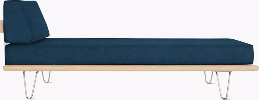 Side view of a modern blue daybed featuring a minimalistic design with a wooden base and metal legs.