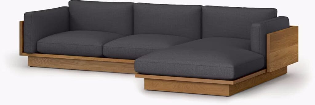 Contemporary gray sectional sofa with wooden base and armrests, part of the Symme Collection.