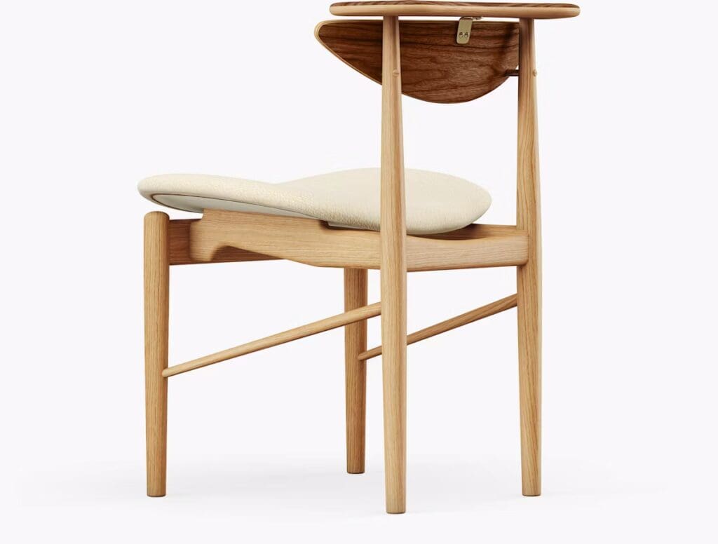 Side view of a modern chair with a light wood frame and a cream-colored seat cushion.