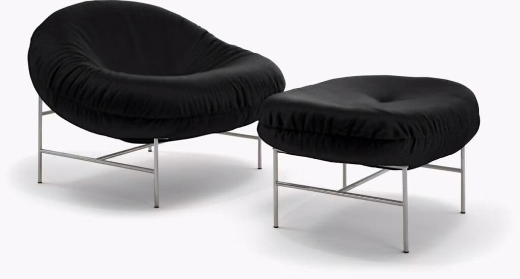 Black lounge chair and ottoman with a modern design featuring a cushioned seat and a sleek metal frame.