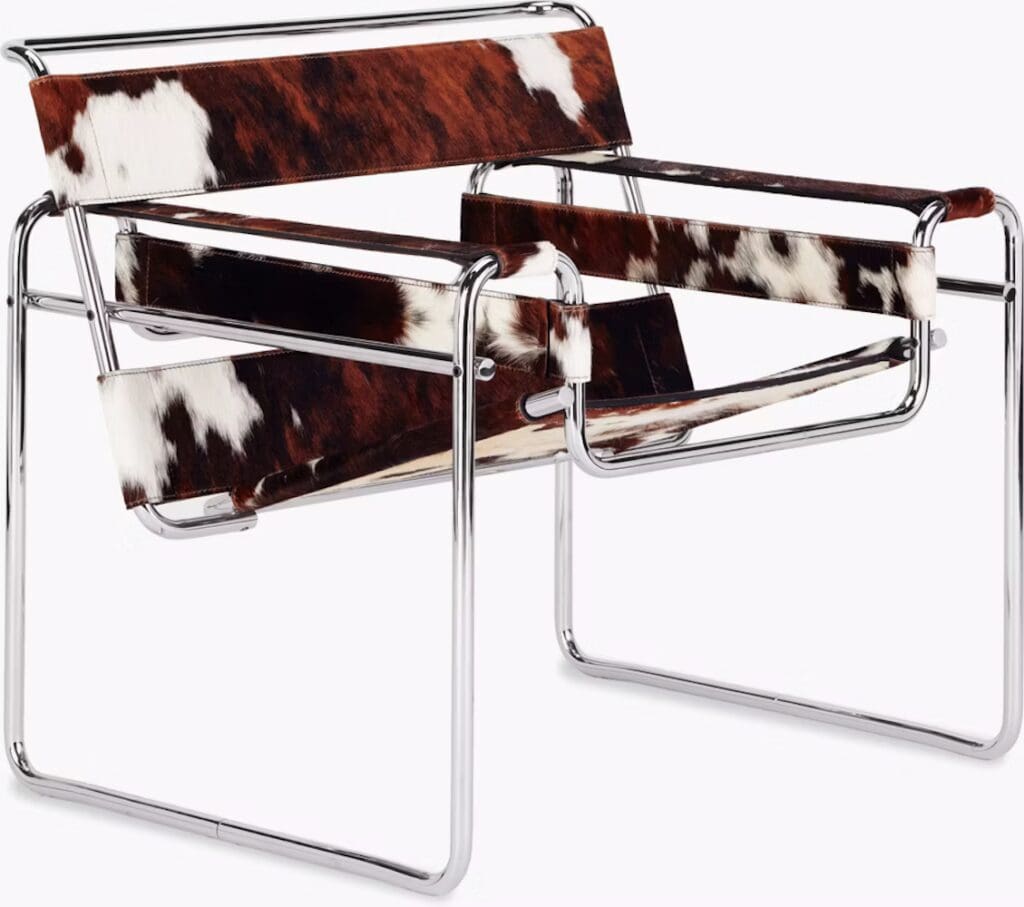 A modern chair featuring a chrome frame with cowhide upholstery in a brown and white pattern.