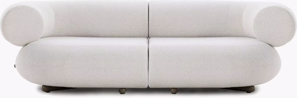 Front view of a modern, rounded white sofa with soft upholstery and circular armrests.