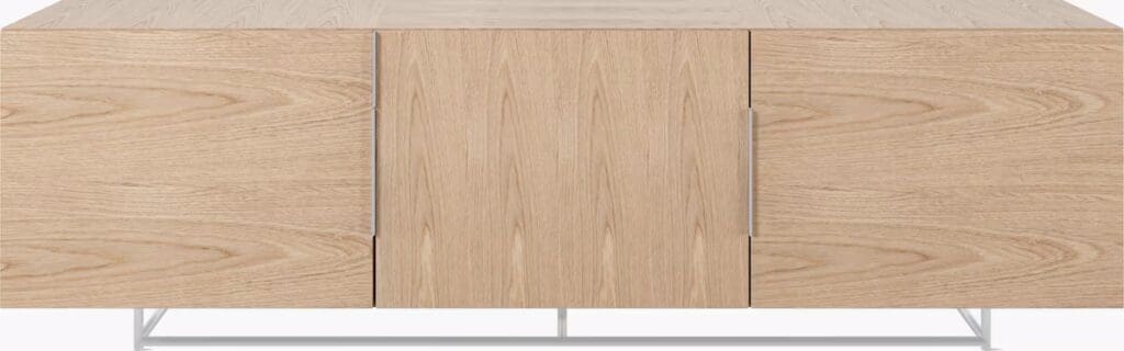 A modern wooden media cabinet with a light oak finish, featuring two side doors and a central opening, set on a minimalist metal base.